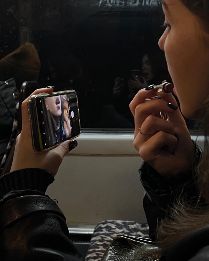 a woman taking a photo with her cell phone