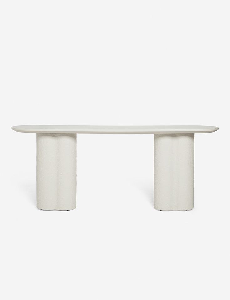 a white table sitting on top of a white floor