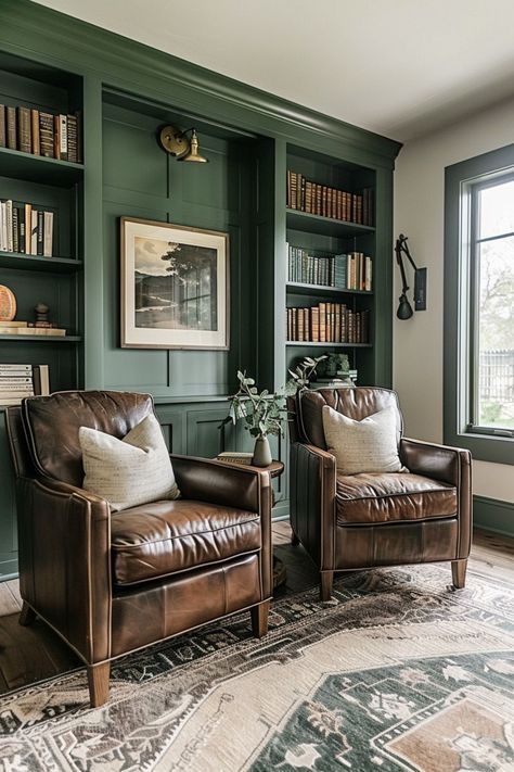 two leather chairs sitting in front of a bookshelf