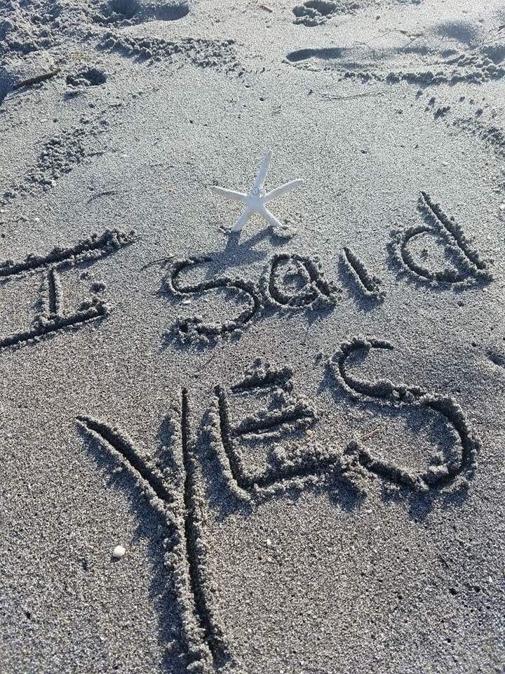 there is a starfish on the beach and it says happy new year written in sand