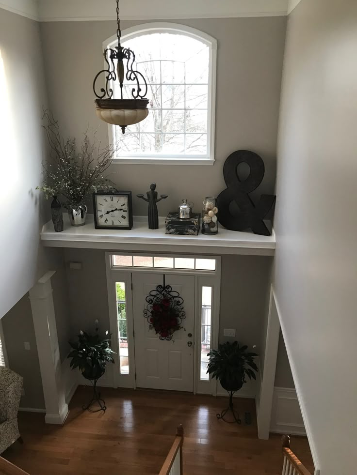 an overhead view of a house with wood floors and white painted walls, including the front door