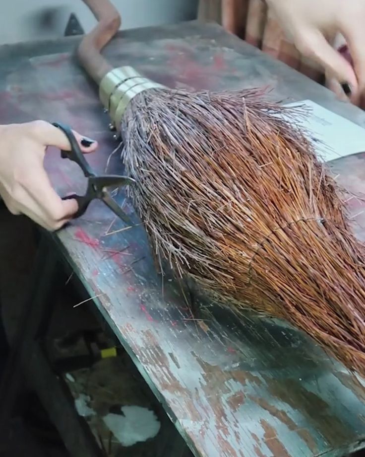 someone is using scissors to cut grass on a piece of metal with red and green paint