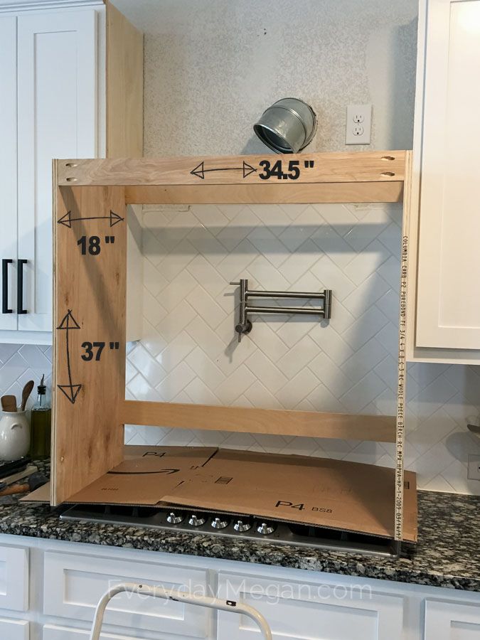 a kitchen with white cabinets and an open shelf on the counter top that is measuring height