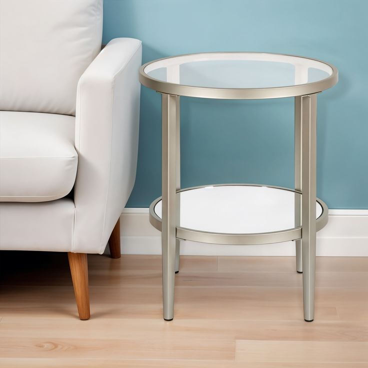 a white chair sitting next to a glass table on top of a hard wood floor