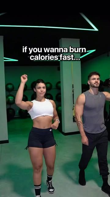 a man and woman standing next to each other in front of a gym equipment room