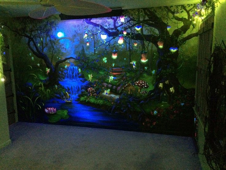 a room with a large mural on the wall and lights in the trees above it