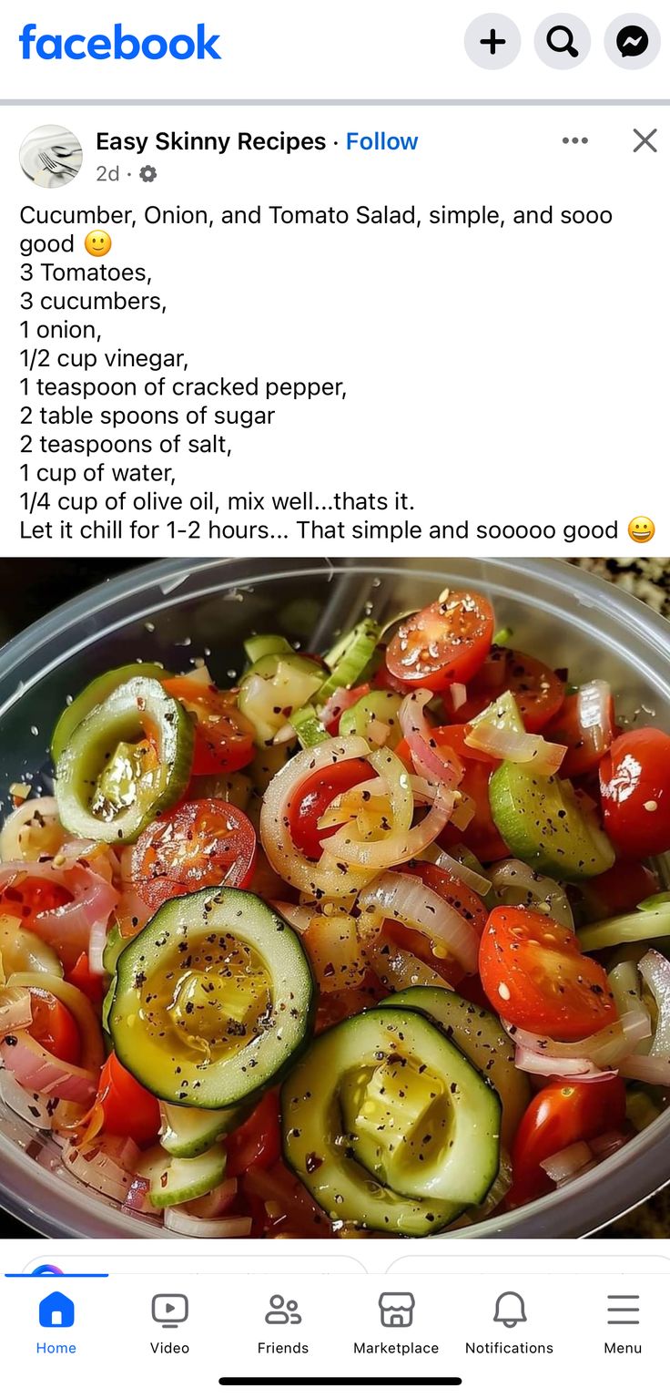 a bowl filled with cucumber, onion and tomato salad on top of a table