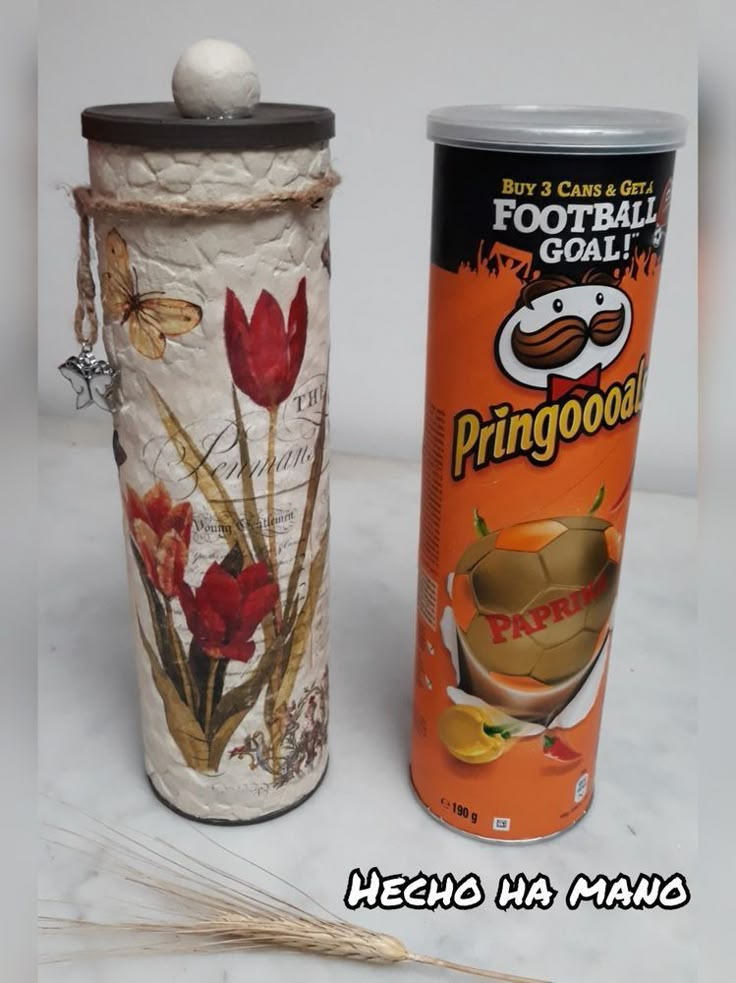 two tins with flowers on them sitting next to each other in front of a white background