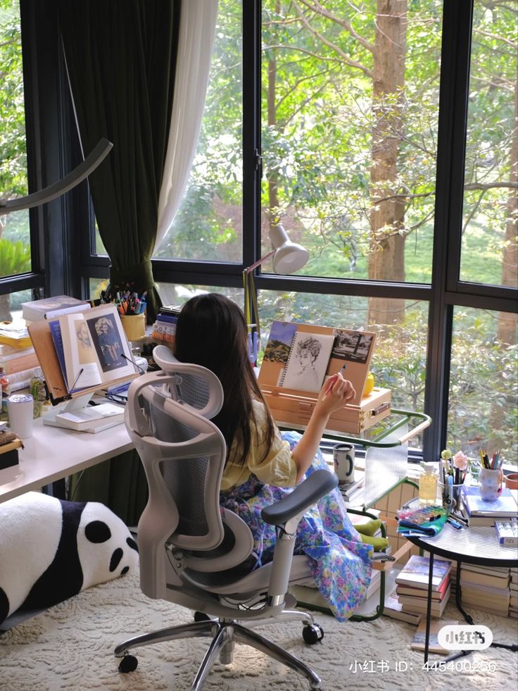 a woman sitting in an office chair next to a panda bear