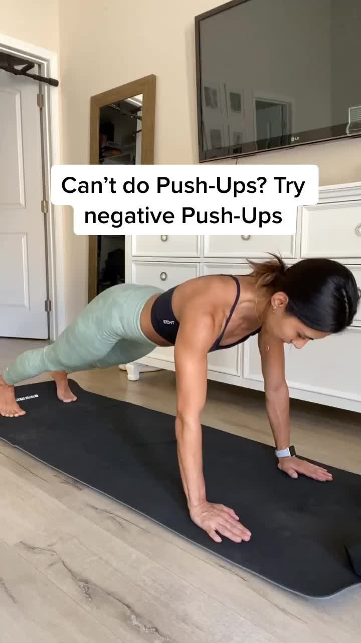 a woman doing push ups on a yoga mat with the words can't do push - ups? try negative push - ups