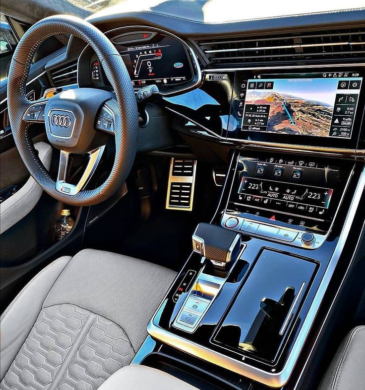 the interior of an audi car with dashboard, steering wheel and touchscreens showing