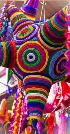 an elephant made out of crochet is hanging from the ceiling in front of other decorations