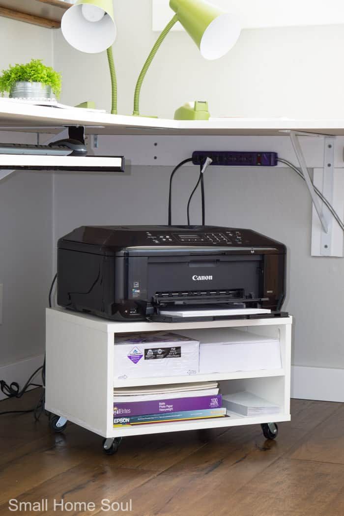 a printer on top of a shelf in a room