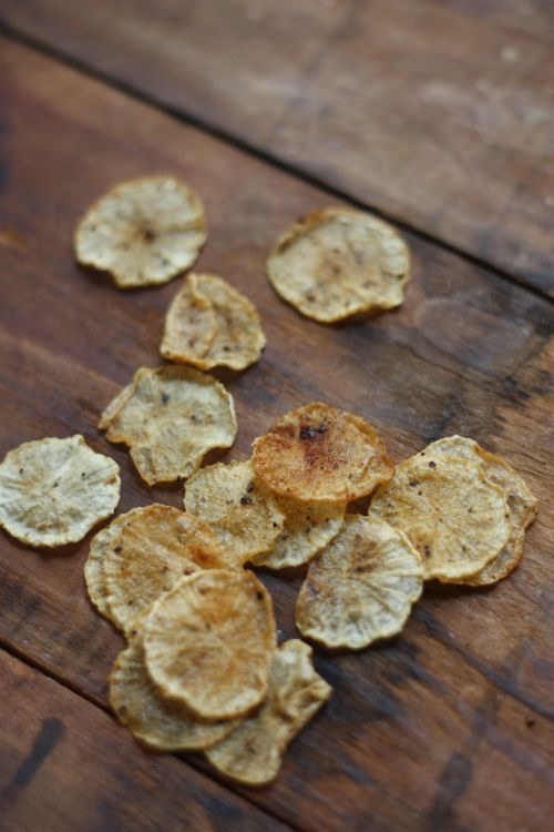 some chips are on a wooden table and have been cut into small pieces