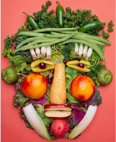 a head made up of vegetables and fruits with an angry look on it's face