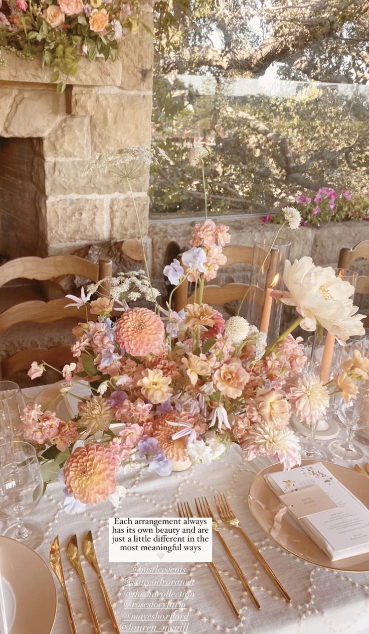 the table is set with flowers and place settings