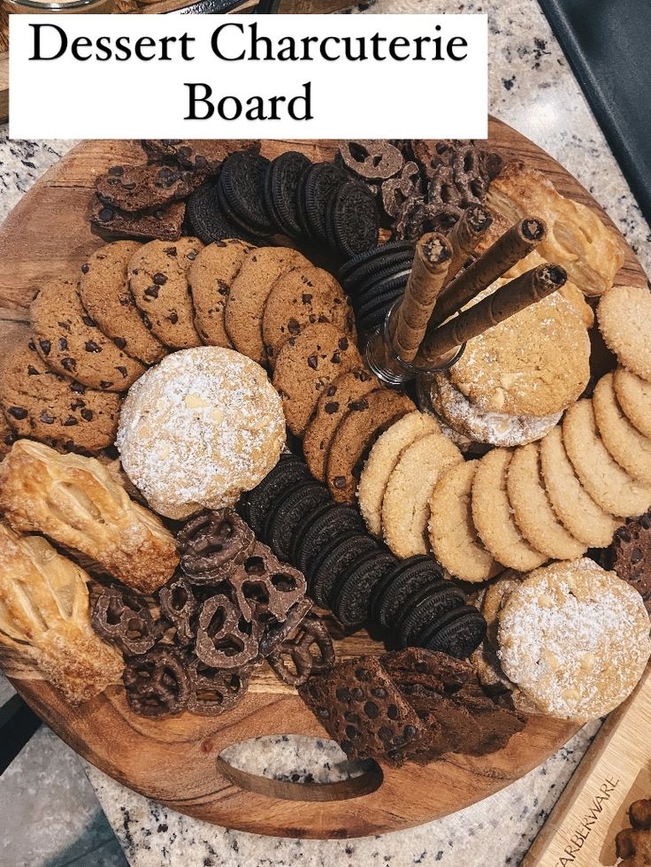 a wooden platter filled with cookies and crackers