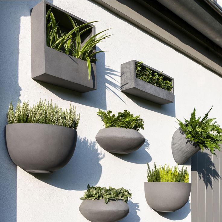 several planters mounted to the side of a building