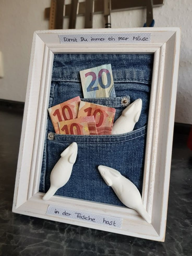 two fake white dolphins sticking out of the back pocket of a pair of blue jeans