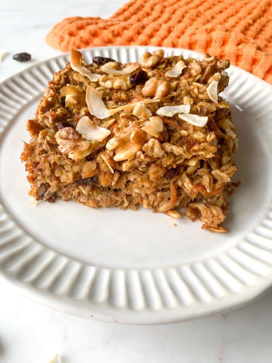 a white plate topped with granola and nuts