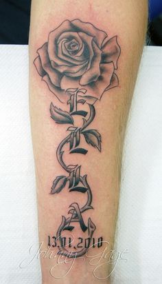 a black and white rose with the word faith on it's lower half leg