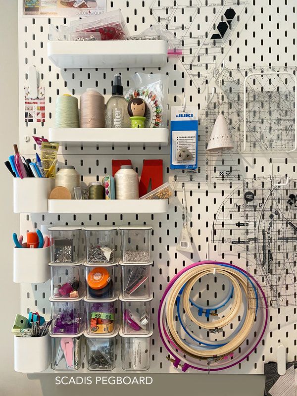 the pegboard is organized with craft supplies and other things to make it look like shelving