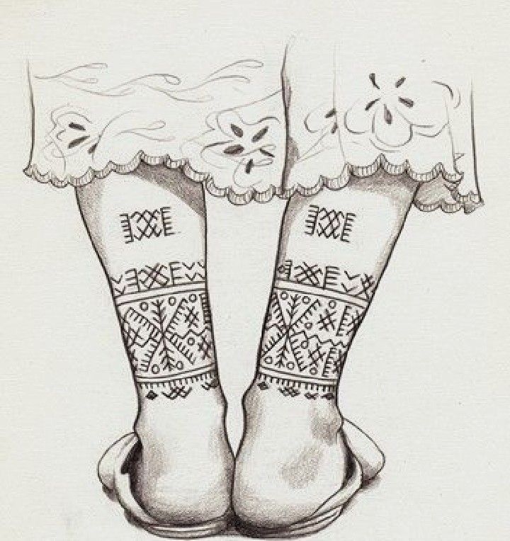 two feet with tattoos on their legs and laces around them, both showing the same pattern