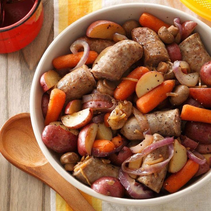 a bowl filled with meat, potatoes and carrots