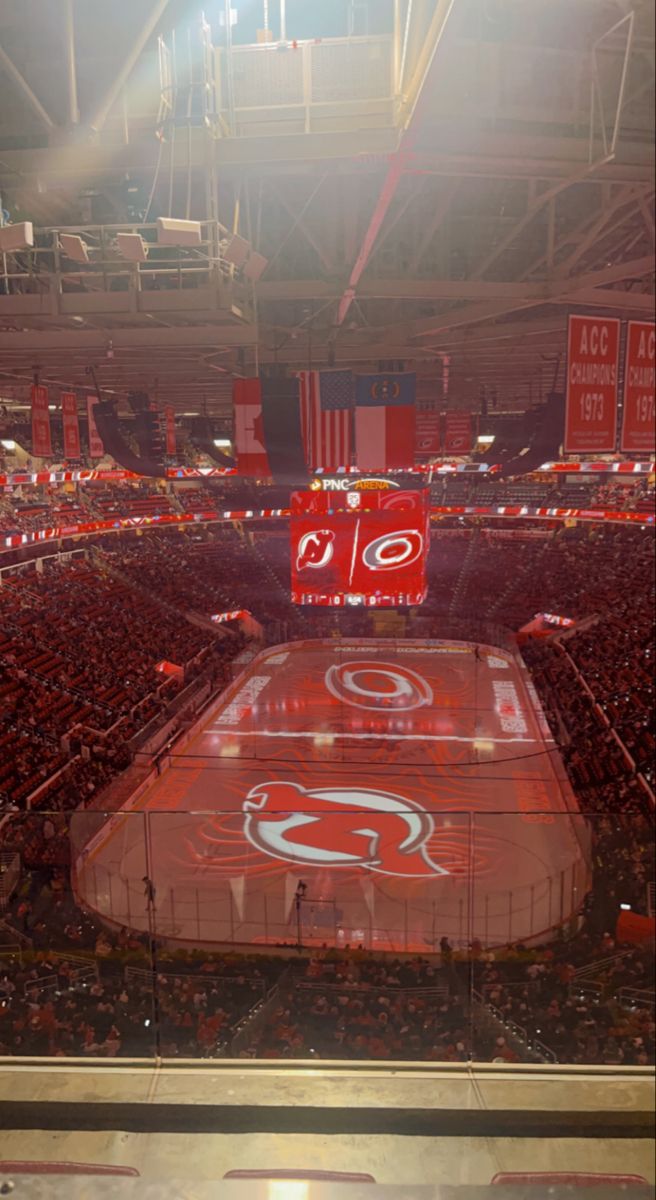 the inside of an arena at a sporting event with red and white paint on the floor