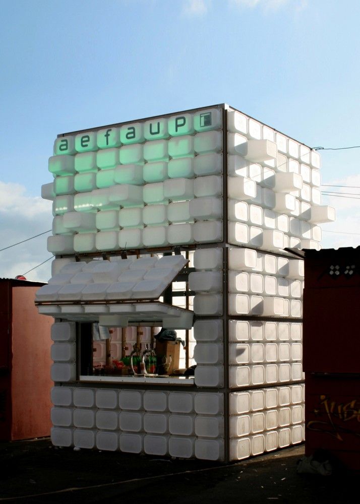 a building made out of plastic bottles and containers