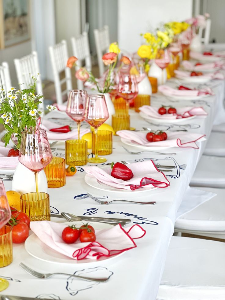 a long table is set with plates and glasses