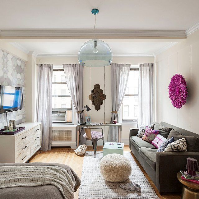 a living room filled with furniture and a flat screen tv on top of a wall