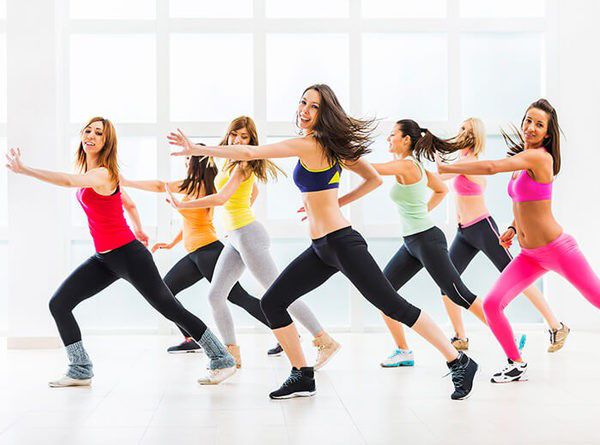 a group of young women dancing in a dance studio