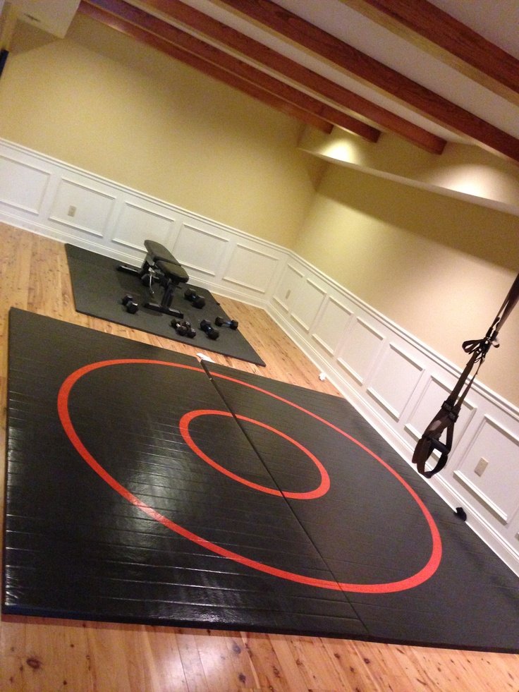 a gym room with an exercise mat on the floor