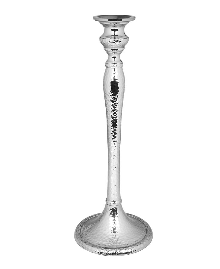 a tall silver candle holder on a white background with a black dot in the middle