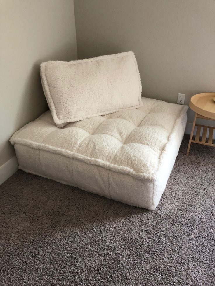 a white futon couch sitting in a corner