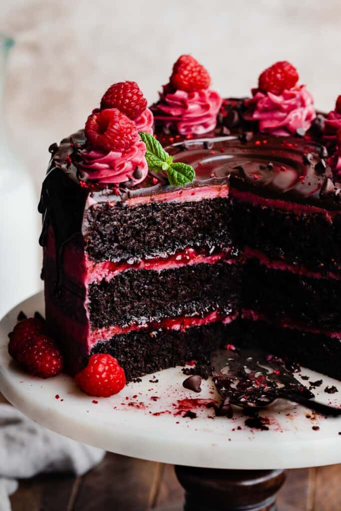 a chocolate cake with raspberries and frosting