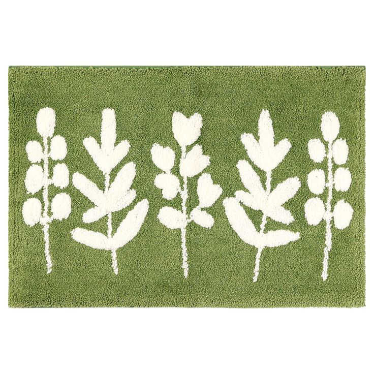 a green rug with white leaves on it