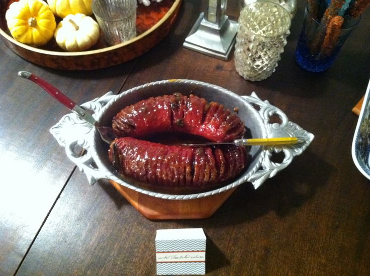 there is a large sausage in a bowl on the table next to other food items