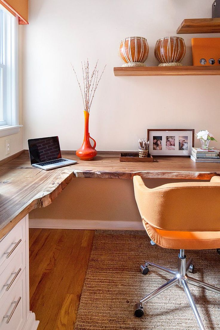 an office desk with a laptop computer on it and a chair in front of it