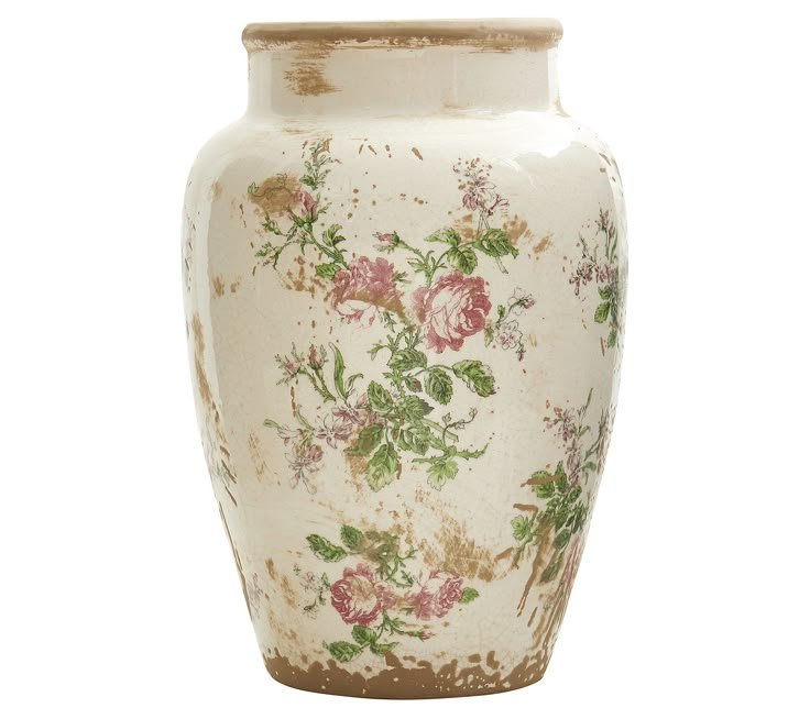 a white vase with pink and green flowers painted on the front, sitting against a white background