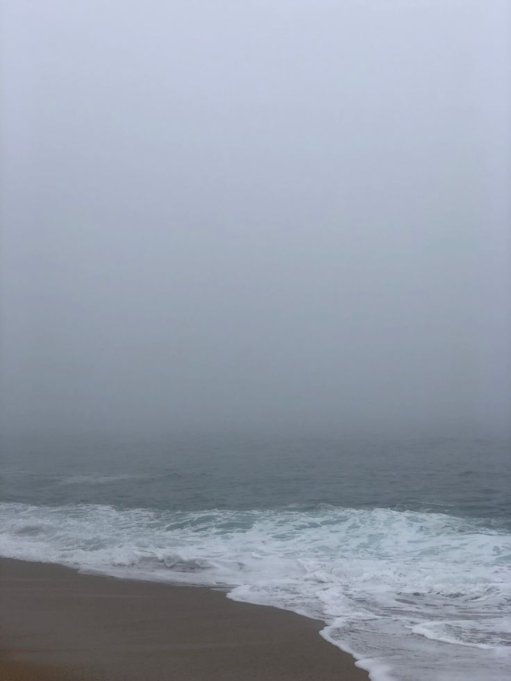 the beach is covered in fog and water