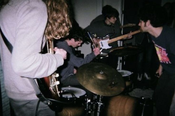 a group of people playing instruments in a room