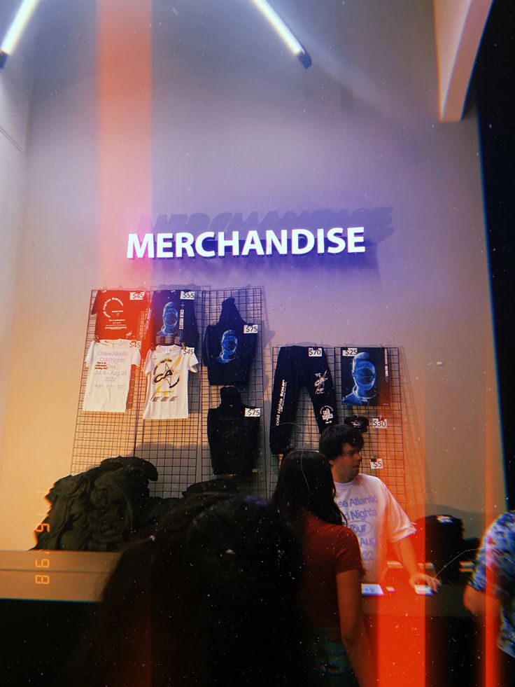 band shirts and hoodies hung up on the wall under "merchandise" sign Merch Stand Ideas, Concert Merch Display, Band Merch Display, Chase Atlantic Merch, Chase Atlantic Concert, Merch Stand, Concert Band Merch Relaxed Fit T-shirt, Wedding Merch, Merch Display