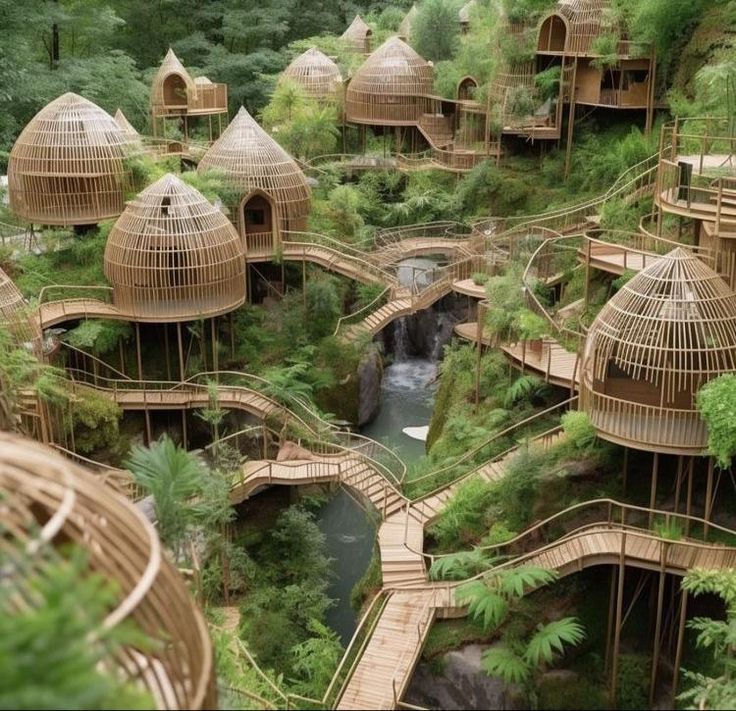 an aerial view of bamboo huts in the woods with water running through them and trees growing on either side