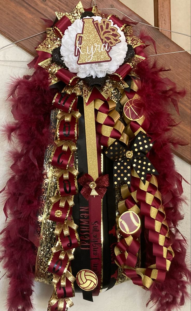 a red and gold christmas wreath hanging on the wall