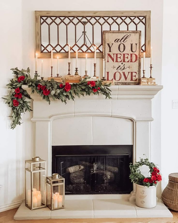 a fireplace decorated with candles and greenery