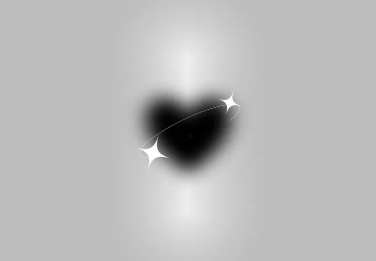 a black heart shaped object with white stars in the center on a light gray background