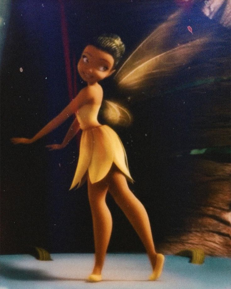 the animated tinkerbell is standing in front of an image of a man and woman