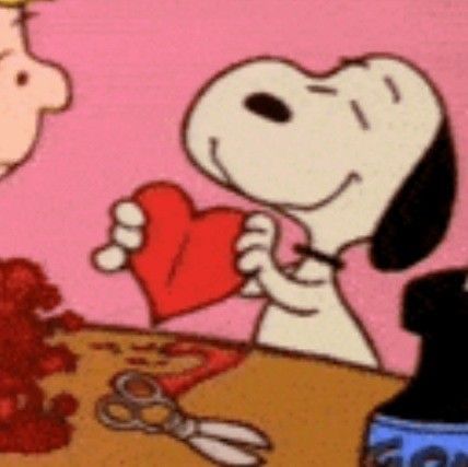 a cartoon character holding a heart next to a dog